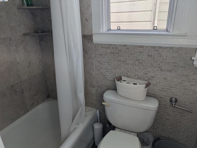 bathroom with toilet and shower / bath combo