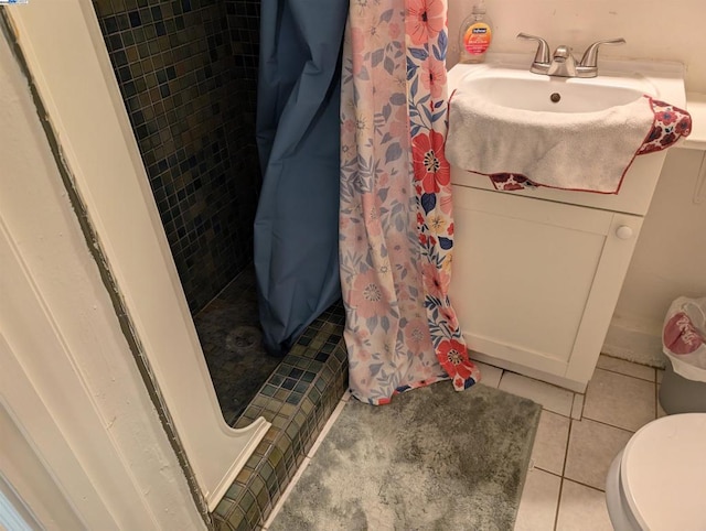 bathroom with toilet, a shower with shower curtain, tile patterned floors, and sink