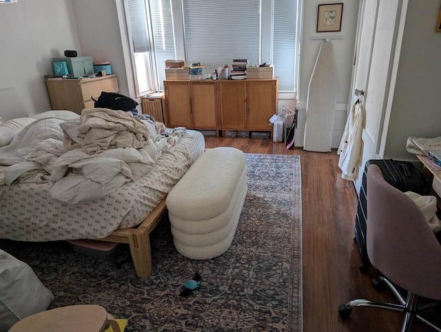 bedroom featuring radiator and wood-type flooring