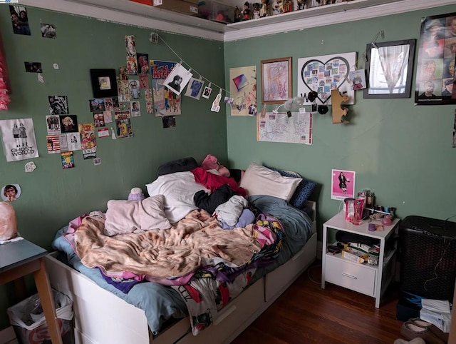 bedroom with dark wood-type flooring