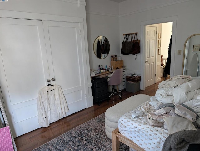 bedroom with a closet and dark wood-type flooring