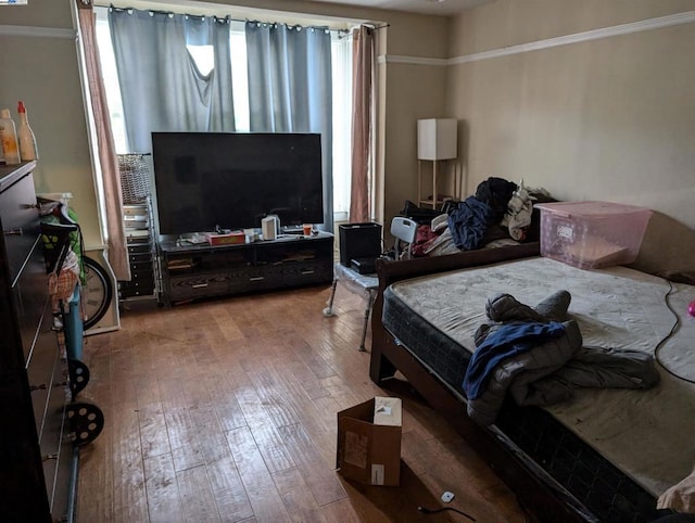 bedroom with hardwood / wood-style flooring