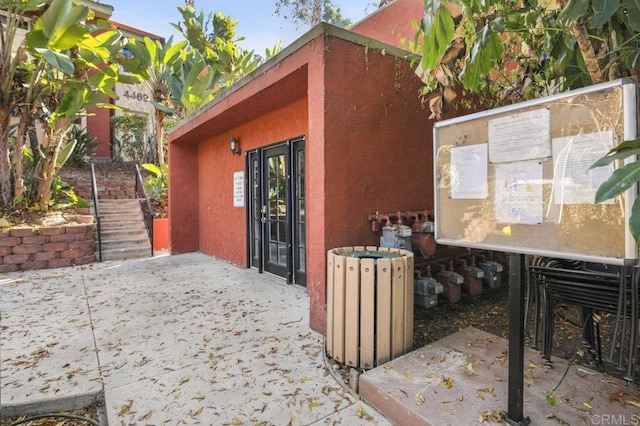 view of property exterior with a patio area