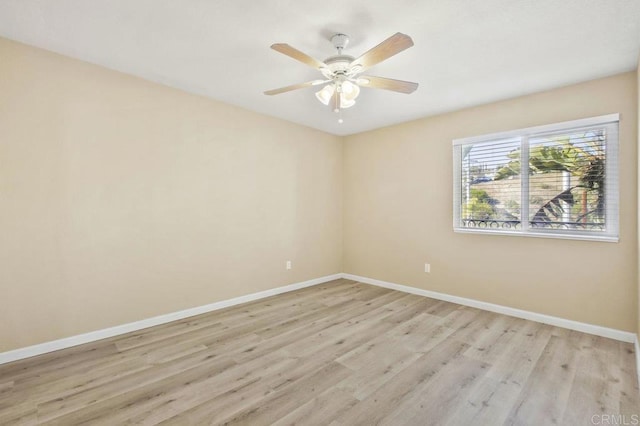 spare room with ceiling fan and light wood-type flooring