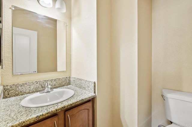 bathroom featuring toilet and vanity