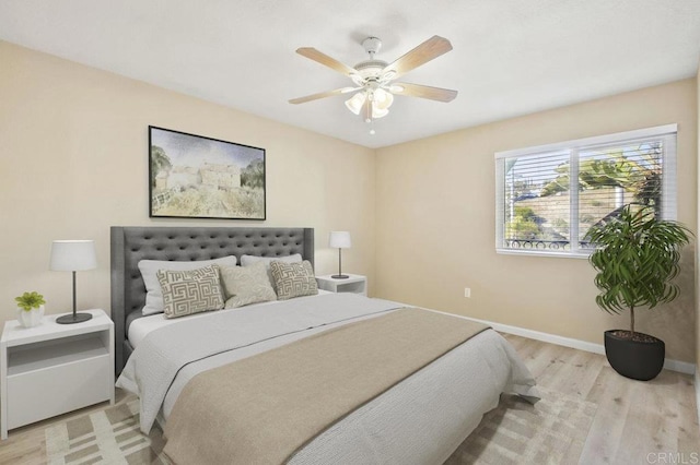 bedroom with ceiling fan and light hardwood / wood-style floors