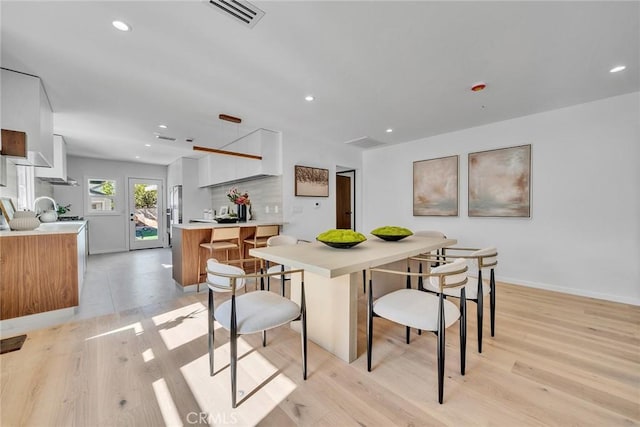 dining space with light wood-type flooring