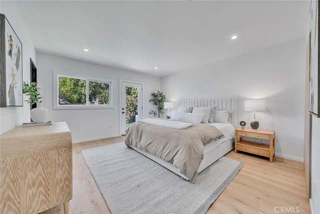 bedroom with access to exterior and light wood-type flooring