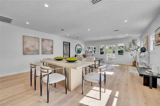 dining room with french doors and light wood-type flooring