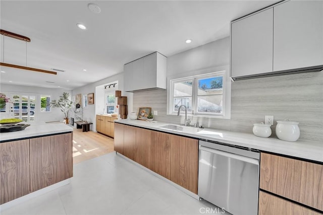 kitchen with sink, white cabinetry, backsplash, and dishwasher