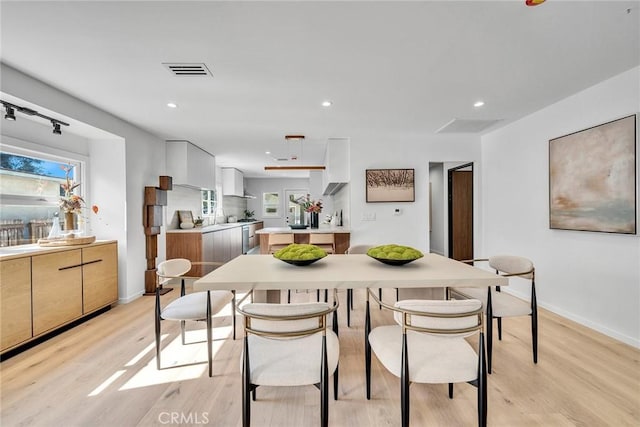 dining area with light hardwood / wood-style floors