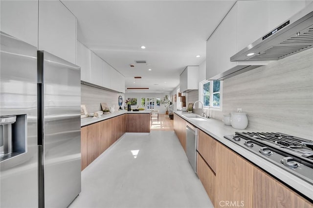 kitchen featuring sink, white cabinetry, light brown cabinets, and stainless steel appliances