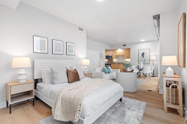 bedroom with light hardwood / wood-style floors