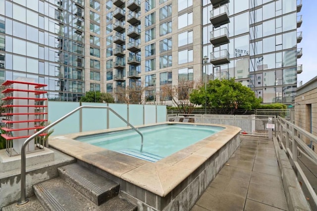 view of pool featuring a hot tub