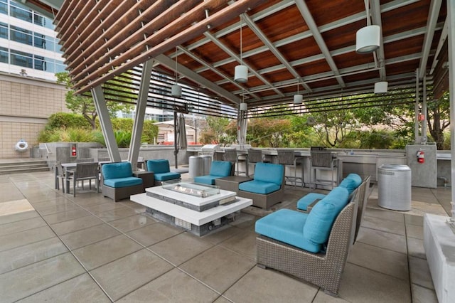 view of patio / terrace featuring a gazebo, an outdoor living space with a fire pit, and an outdoor bar