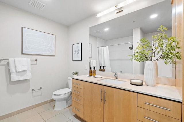 bathroom featuring toilet, tile patterned flooring, walk in shower, and vanity