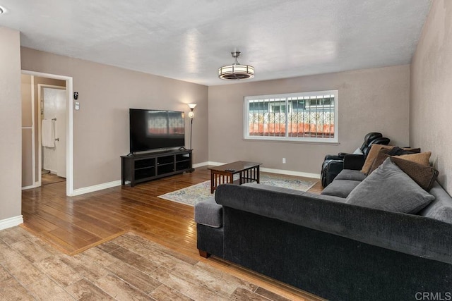 living area with wood finished floors and baseboards