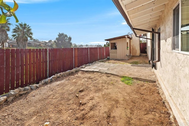 view of yard with a fenced backyard and an outdoor structure