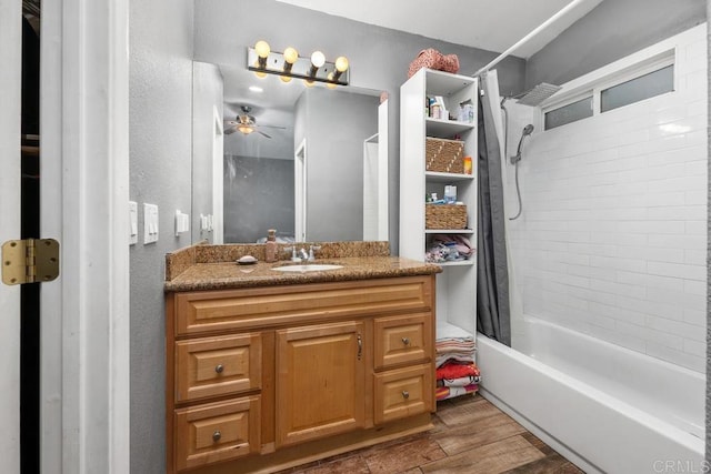 bathroom with ceiling fan, shower / bath combo, wood finished floors, and vanity