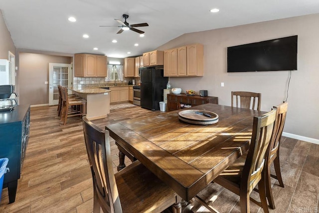 dining area featuring lofted ceiling, light wood finished floors, recessed lighting, and baseboards