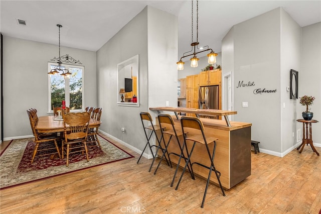 dining room featuring a notable chandelier and light wood-type flooring