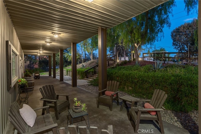 patio terrace at dusk featuring ceiling fan