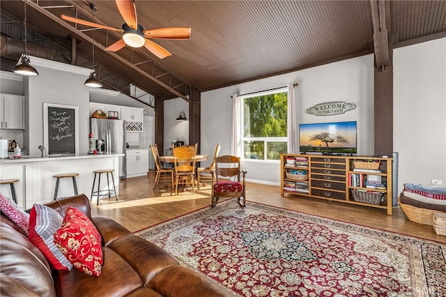 living room with lofted ceiling, hardwood / wood-style floors, wooden ceiling, and ceiling fan