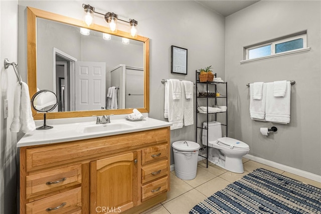 bathroom with an enclosed shower, vanity, tile patterned floors, and toilet