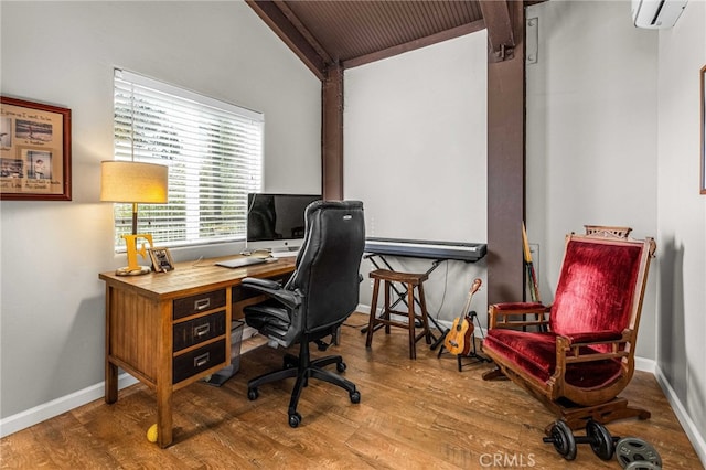 office space featuring wood-type flooring, a wall mounted AC, and vaulted ceiling