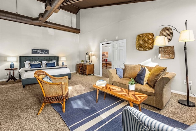 bedroom with a high ceiling and carpet flooring