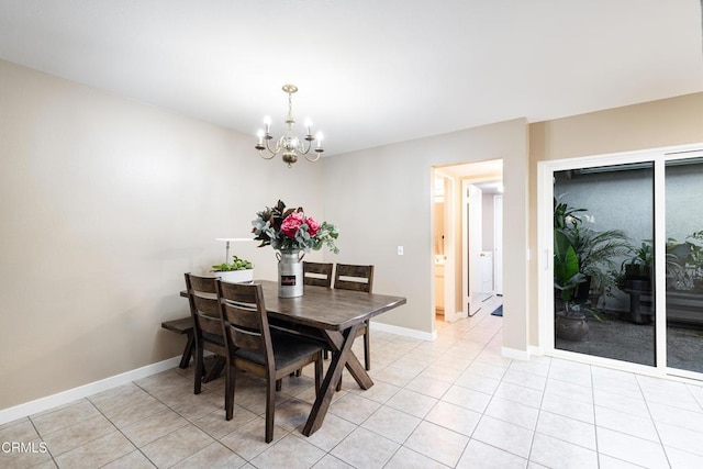 dining room featuring a chandelier and light tile patterned flooring