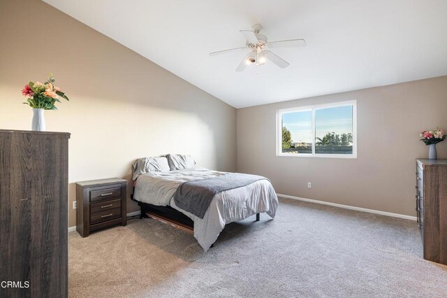 bedroom featuring vaulted ceiling, ceiling fan, and light colored carpet