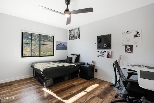 bedroom featuring ceiling fan and dark hardwood / wood-style floors