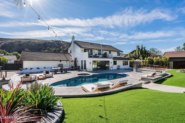 view of swimming pool with a lawn, a patio area, outdoor lounge area, and an in ground hot tub