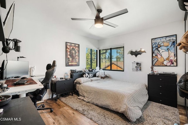 bedroom with ceiling fan and hardwood / wood-style flooring