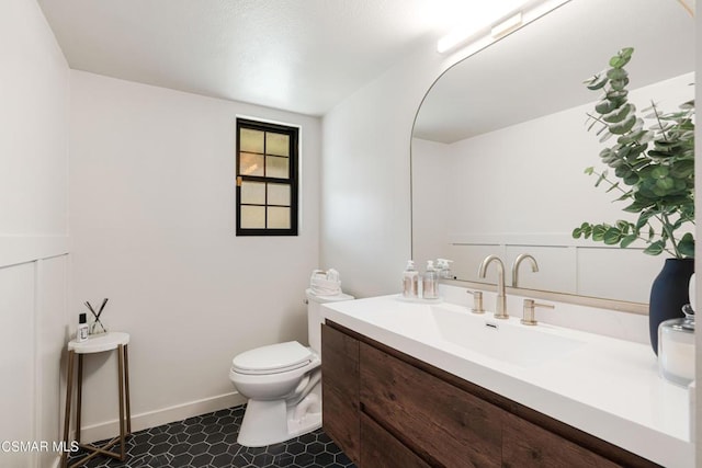 bathroom with toilet and vanity