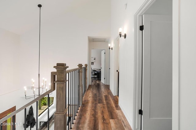 hall featuring dark hardwood / wood-style flooring and a chandelier