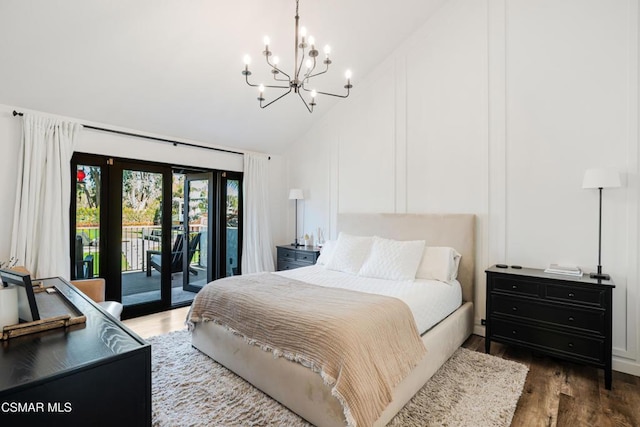 bedroom with access to outside, dark hardwood / wood-style floors, a chandelier, and lofted ceiling