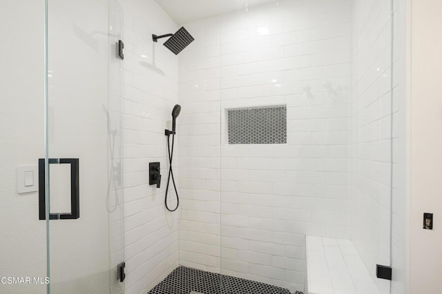 bathroom with a shower with door