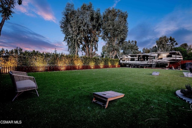 view of yard at dusk