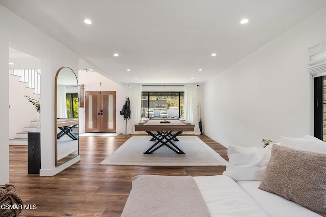 living room with dark hardwood / wood-style flooring and pool table