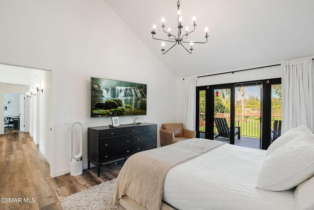 bedroom featuring high vaulted ceiling, dark wood-type flooring, access to outside, and a chandelier