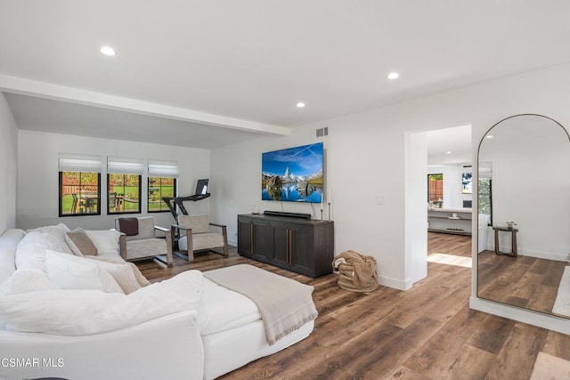 living room featuring beam ceiling and hardwood / wood-style flooring