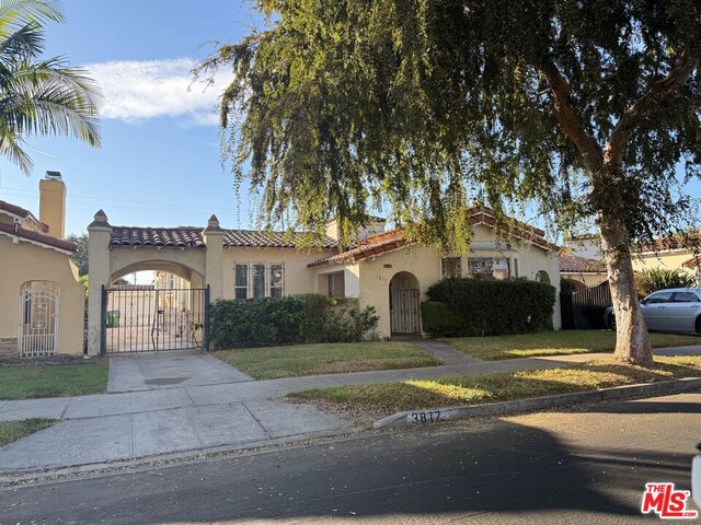 mediterranean / spanish house with a front yard