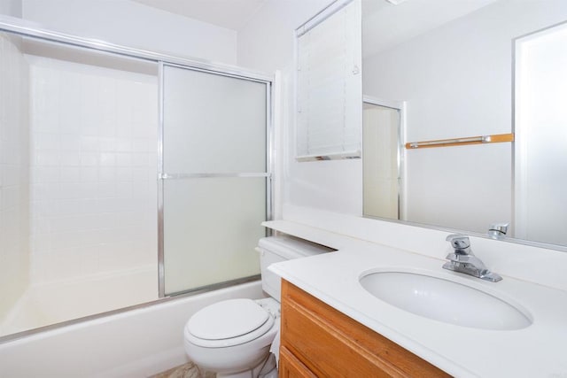 full bathroom featuring bath / shower combo with glass door, toilet, and vanity