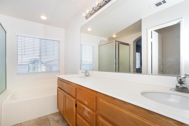 bathroom featuring separate shower and tub, vanity, and tile patterned flooring