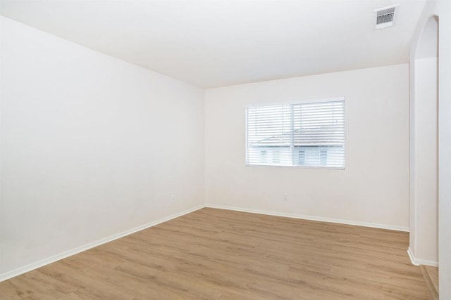 empty room with light hardwood / wood-style flooring