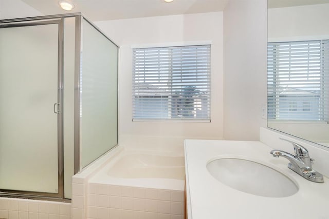 bathroom featuring separate shower and tub and vanity