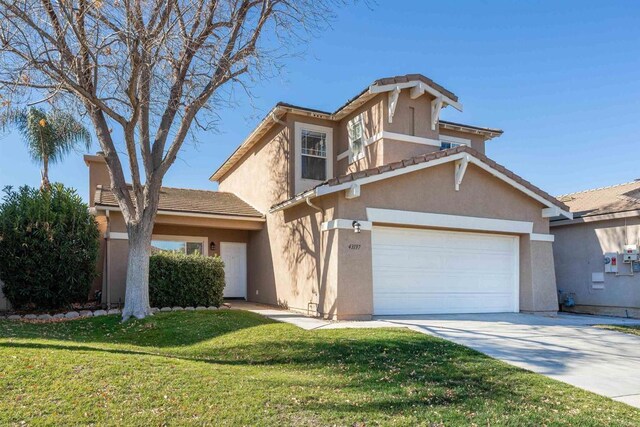 view of property featuring a front yard and a garage