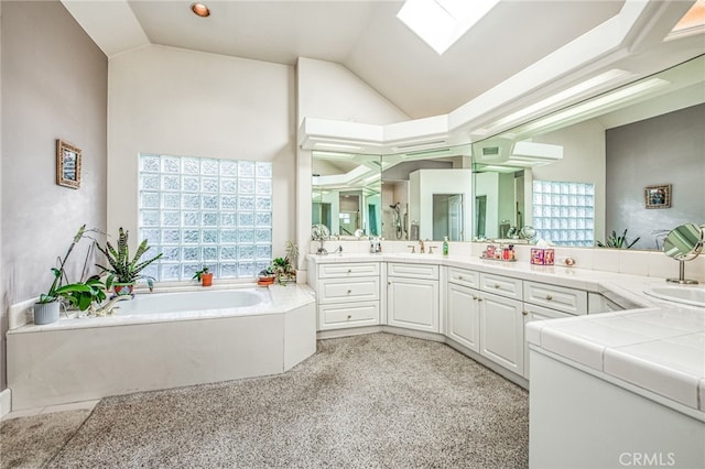 bathroom featuring vanity, a healthy amount of sunlight, plus walk in shower, and a skylight